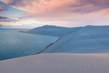 Desert at sunrise, morning glow over dunes inland sea of the Sea line Desert just out of Doha, Qatar.