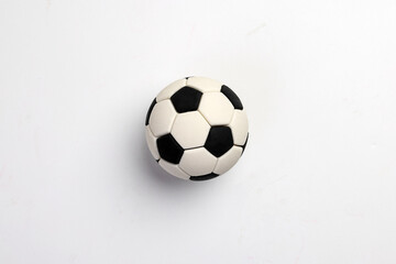 Naklejka premium miniature toy football soccer ball black and white over white background copy text space concept