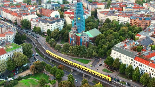Aerial drone view of Kreuzberg, Berlin, Germany. Residential district with greenery, cathederal, moving trains and buildings