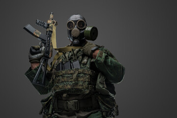 Fototapeta premium Studio shot of russian soldier dressed in protective uniform and gas mask against gray background.