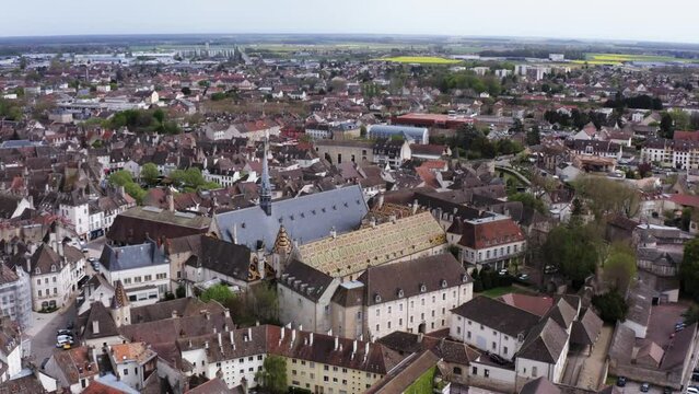 Aerial pan shot of iconic French town Beaune showing off the unique Burgundian Romanesque style of the buildings
