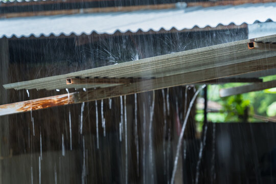 Rain On A Tin Roof. Rain Falling From The Roof. Rainy Day Nature Background. Selective Focus