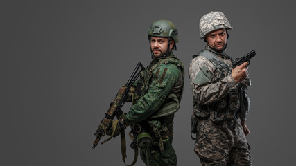 Portrait of nato and russian military men dressed in camouflage protective uniform.