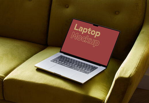 Metal Laptop Mockup on a Green Sofa at Home