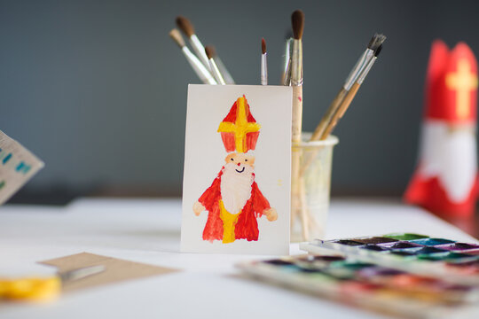 children's drawing - card for day of saint nicholas on table background for traditional Dutch holiday sinterklaas. craft for kids