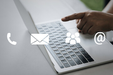 Contact us or Customer support hotline people connect. Business people using a laptop computer with the (email, call phone, mail) icons.
