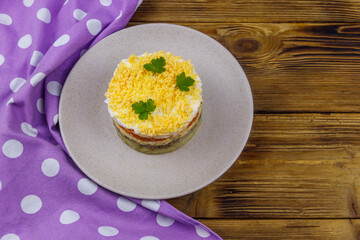 Traditional russian salad Mimosa on wooden table. Top view