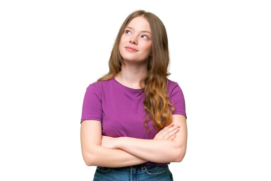 Young pretty woman over isolated background looking up while smiling