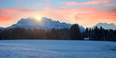 romantic winter sunset bavarian alps with beautiful sky. last sunrays over the mountains