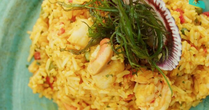 Amazing slow motion close-up of the famous and delicious Peruvian seafood dish "Arroz con mariscos" at a beachfront restaurant in northern Peru.