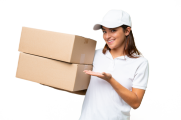 Delivery caucasian woman holding boxes isolated on green chroma background extending hands to the side for inviting to come
