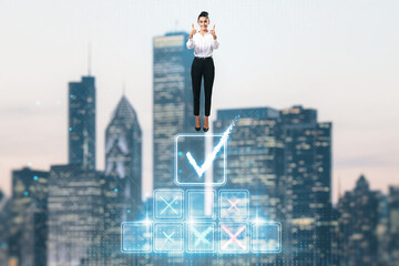 Fototapeta na wymiar Attractive young european businesswoman standing on top of digital stairs to success on blurry city background and showing thumbs up. Futuristic goal achievement concept.