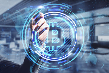 Close up of businessman hand pointing at creative glowing bitcoin hologram and map on blurry office interior background. Crytpocurrency, nft, metaverse and blockchain concept. Double exposure.