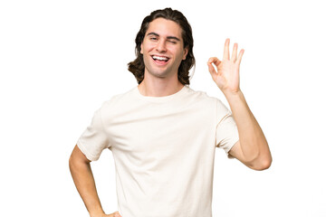 Young caucasian man isolated on green chroma background showing ok sign with fingers