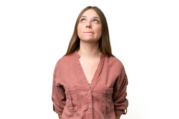 Young beautiful blonde woman over isolated background and looking up