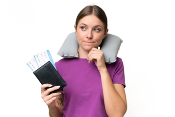 Young beautiful blonde woman with Inflatable travel Pillow over isolated background having doubts and thinking