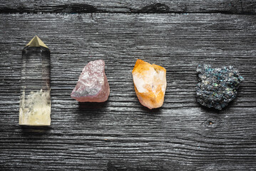 Various mineral stones on the black wooden table background.