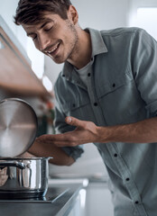 close up. young man looking into the pan.