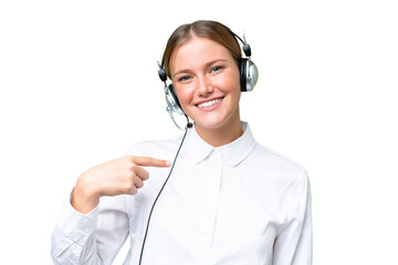 Telemarketer caucasian woman working with a headset over isolated background with surprise facial...