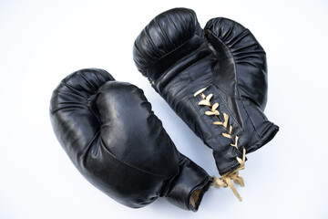 Antique boxing gloves on a white background. Black boxing gloves on white isolate. Boxing career