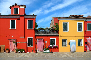 Fototapeta na wymiar Colorful houses against cloudy blue sky
