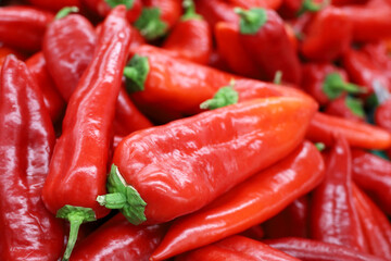 Ramiro pepper close up. Red sweet peppers on a market, paprika, vegetable background