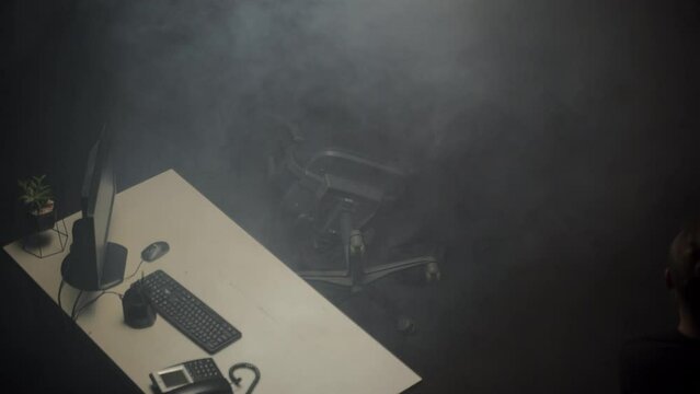 An accident in the office - a fallen computer chair and smoke. Mystery concept