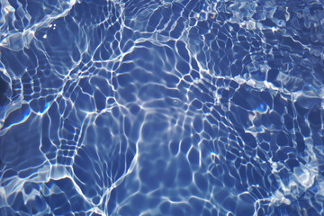 Bluewater waves on the surface ripples blurred. Defocus blurred transparent blue colored clear calm water surface texture with splash and bubbles. Water waves with shining pattern texture background.