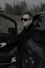 brutal businessman in a car. black and white portrait