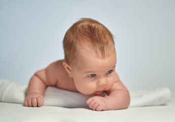 Close-up portrait of a newborn on a light background