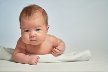 Close-up portrait of a newborn on a light background