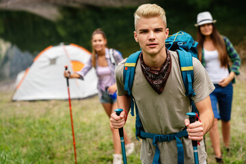 Adventure, travel, tourism, hike and people concept. Group of happy friends with backpack outdoors