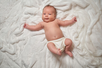 Portrait of a newborn baby lying on a soft, fluffy surface