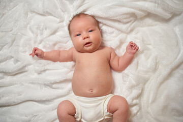 Portrait of a newborn baby lying on a soft, fluffy surface