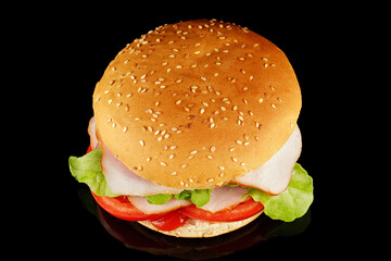 burger with lettuce, tomato, cheese and cutlet top view. burger isolated on black background