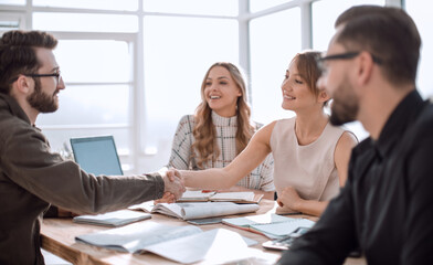 happy business team cheering near the desktop.