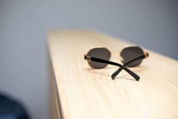 Fototapeta na wymiar Black glasses in focus lie on the table.