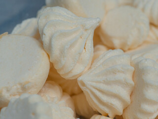 white swirly meringues in kitchen for frosted cake topping
