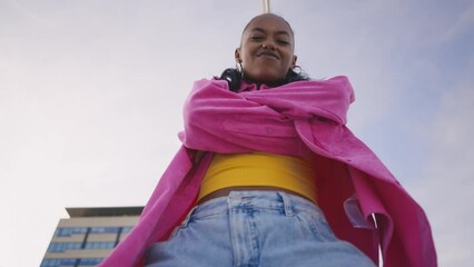Cinematic footage of a professional hip hop female dancer outddor . Teenager girl with fashionable clothes dancing in a colored modern area of the city