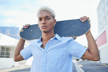 Black man, serious with a skateboard and city, urban background and trendy, hipster fashion in...