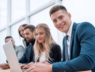 young employee and his colleagues sitting at the office Desk