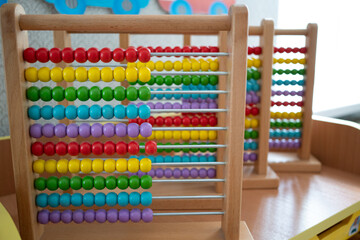 School abacus with colorful beads, closeup view, copy space. Kids learning, kids math class concept