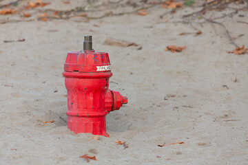 red fire hydrant on the beach - Powered by Adobe