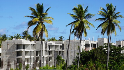Fototapeta na wymiar palm trees and new buildings in the residential complex Plaza Artistica in Punta Cana in the Dominican Republic in the month of January 2022