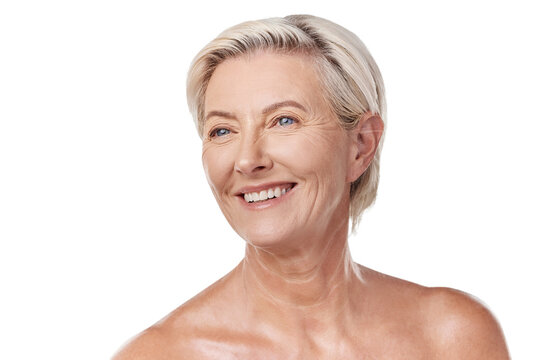 Beautiful mature caucasian woman posing topless and isolated against a pink background copyspace . Happy senior woman with glowing skin. Good skincare and a healthy routine is self care for your skin