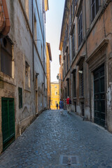 Fototapeta na wymiar One of the many narrow streets (Via della Tribuna di Campitelli) in Rome, Italy