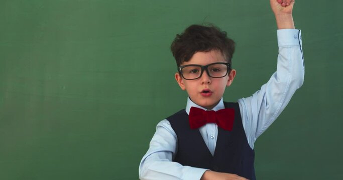 Funny kid against green chalkboard
