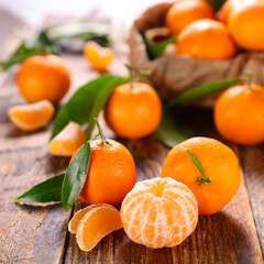 clementine fruit orange and leaf on wood background
