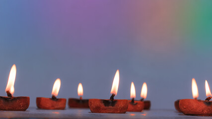 burning diya lamps for diwali and karthigai Deepam festival celebration colorful background.