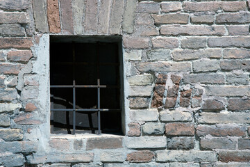 Fototapeta na wymiar Urbino, (PU), Italy - August 10, 2022: An old wall and iron grate, Urbino, Pesaro Urbino, Marche, Italy, Europe